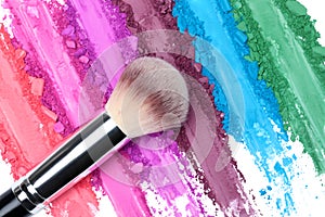 Broken and smashed color make-up eyeshadow palette, lay of brush strokes with brush, close-up for background, top view