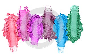 Broken and smashed color make-up eyeshadow palette, lay of brush strokes, on white background, top view