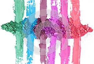 Broken and smashed color make-up eyeshadow palette, lay of brush strokes, on white background, top view