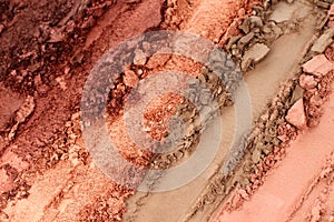 Broken and smashed make-up eyeshadow pallete, lay of brush strokes, close-up for background, top view