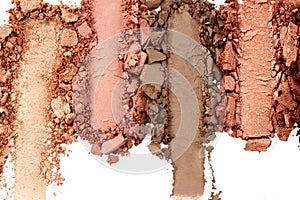 Broken and smashed make-up eyeshadow pallete, lay of brush strokes, on white background, top view. Sample cosmetics concept