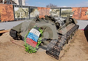 Broken Soviet tank t-34 with a mourning wreath