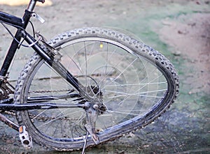 Broken spoke and damage crooked bicycle wheel from crash on the ground background