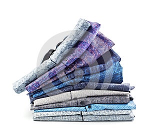 Broken stack of men`s shirts isolated