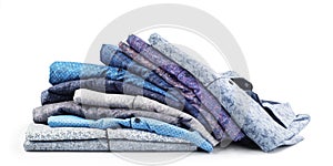 Broken stack of men`s shirts isolated