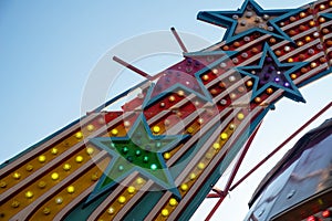 Broken stars on vintage amusement park ride lights colorful bulbs