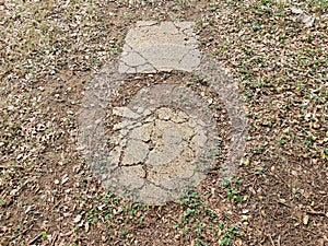 broken stepping stones in path in the grass