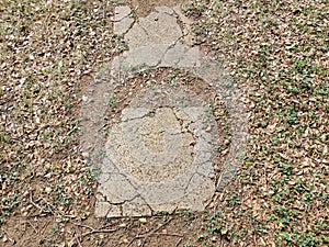 broken stepping stones in path in the grass