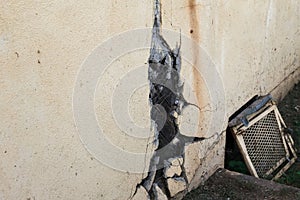 Broken stucco on old building and vent