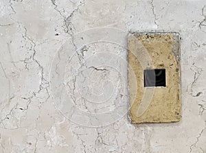 Broken switch board on old marble wall
