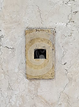 Broken switch board on old marble wall