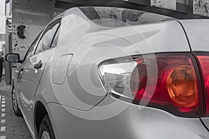 Broken tail light on a gray car