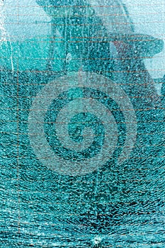 Broken tempered glass background. Broken tempered glass as an abstract background. Broken glass wall outdoor background.