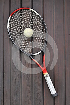 Broken Tennis Racket and old Tennis Ball