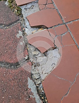 Broken tiles of a pavement