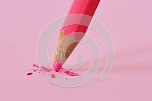 Broken tip of pink pencil on pink background - Concept of violence against women