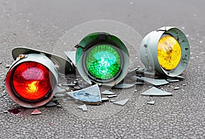 Broken traffic light lying on the street