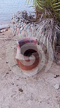 broken trash can on the beach