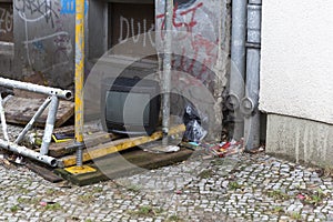 Broken TV Sidewalk With Construction Debris With Abandoned Television Set