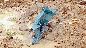 Broken umbrella after storms and floods