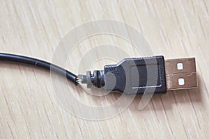 Broken usb cable on a wooden table