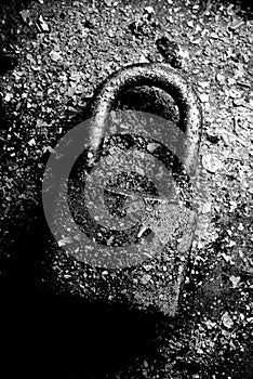 Broken useless padlock in black and white.