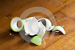 Broken vase on wooden floor