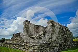 The broken wall of the temple in Tulum exposes the architectural details of the interior of the building.