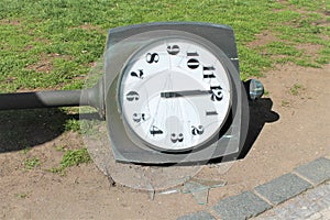 Broken watch dial. The street post with the clock lies on the ground.