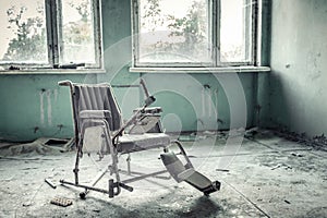 Broken wheelchair in abandoned medical sanitary unit number 126 in Pripyat