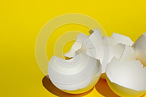 Broken White Chicken Eggshell. White Eggshell Over Yellow Background. Colorful Background.