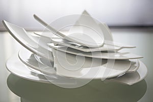 Broken white plates on glass table