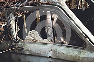 Broken window in an abandoned car/broken glass in an abandoned car
