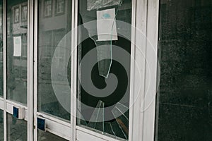 Broken window as a result of an earthquake or vandalism or other negative event.