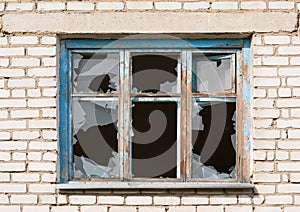 Broken window in a brick building