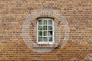 Broken window on brick wall
