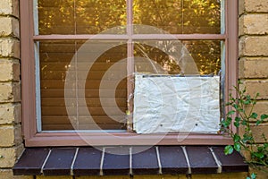 Broken window with cardboard