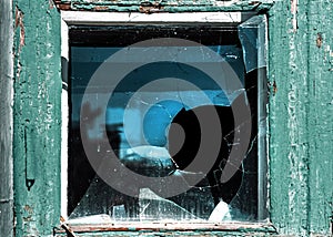 Broken window. Cracked glass with hole. Vandalism, destruction and accident concept