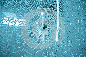 Broken window glass with blue background