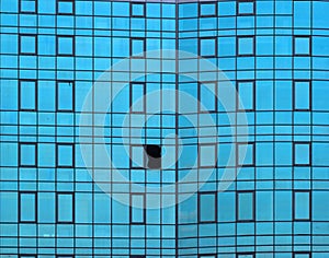 Broken window in glass facade of office building