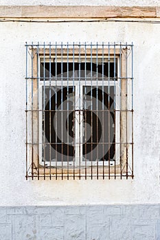 Broken window with grid on a white wall