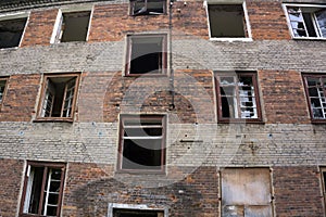 Broken window of an old abandoned factory building.