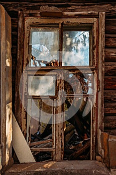 Broken window of old abandoned wooden building