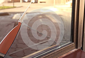 Broken window with sharp smithereens outdoors. Requiring repair