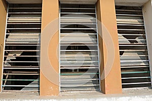 Broken windows of an abandoned building after vandalism