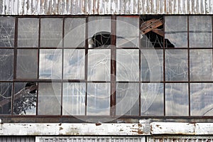 Broken windows at abandoned factory building
