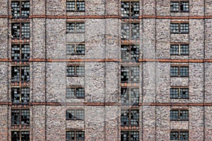 Broken windows on abandoned redbrick building