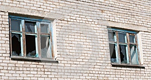 Broken windows in a brick building