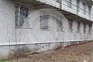 Broken windows on old derelict building. Broken old windows of the building, forged metal bars on the windows in Unrecognized