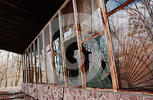 Broken windows at rusty frame on Chernobyl disaster, Ukraine.